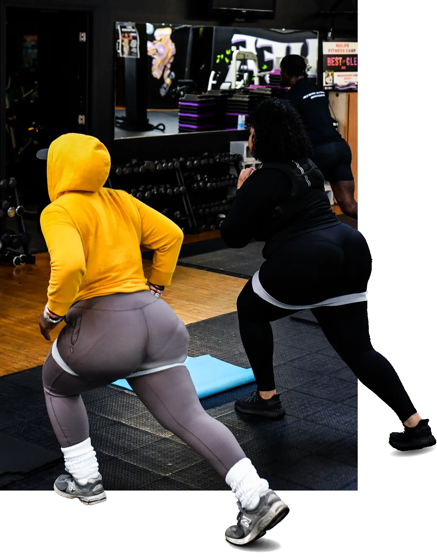 NuLife members doing resistance-band lunges during a coached workout